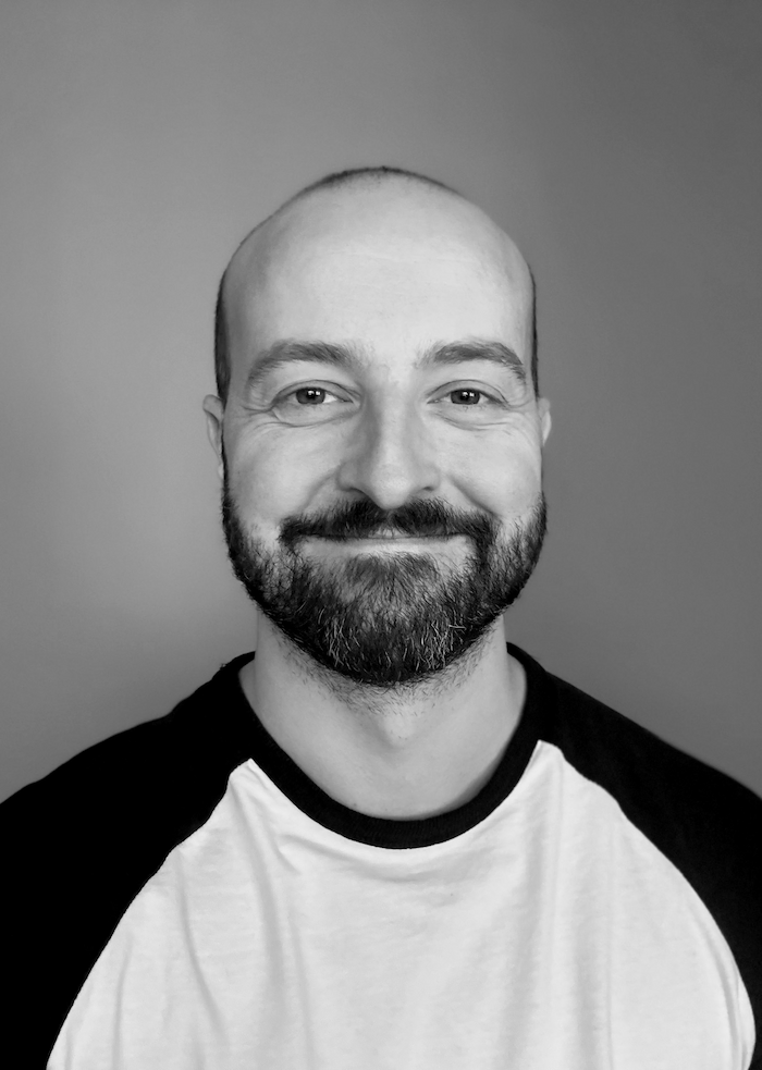 Martin Fischer smiling, with a neutral background.